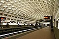 Farragut West station on the Washington Metro, showing modern PIDS electronic displays and the distinctive vaulted design of the stations.