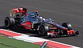 Due to the mutual marketing interest of Vodafone and Verizon, McLaren cars run with Verizon advertisements in North America. This is Jenson Button at the 2012 United States Grand Prix.