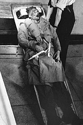 Photograph of the corpse of Glyndwr Michael, strapped to a stretcher in Hackney mortuary