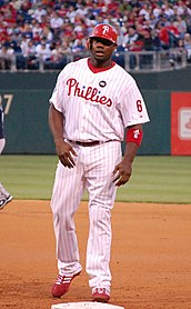 Ryan Howard wearing the current Phillies' white home uniform with red pinstripes and the Harry Kalas patch in 2009