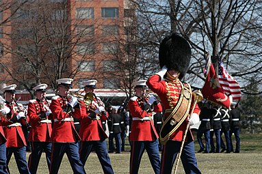 Master Gunnery Sgt Thomas D. Kohl leads the Marine Band during the 60th anniversary of the Battle of Iwo Jima commemoration ceremony at the Marine Corps War Memorial, 2005.