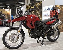 Red BMW F650GS on display at a motorcycle exhibition