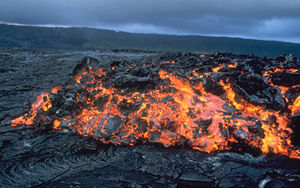 ʻAʻa advances over solidified pāhoehoe on Kīlauea, Hawaiʻi.