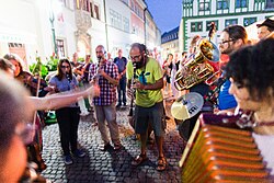 photo of a Jam session of musicians on a cobblestoned street in Germany