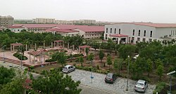 Auditorium and temporary department buildings with permanent buildings in background