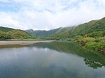 A wide river in a green mountain landscape.