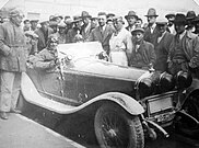 Giuseppe Campari on Alfa Romeo 6C 1750 Compressore; standing in centre (from left) Enzo Ferrari and Achille Varzi