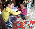 Image 10Girls assembling a puzzle (from Girls' toys and games)