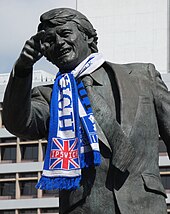 Close-up of a bronze statue of Sir Bobby Robson, former Ipswich and England manager, in one of his typical poses