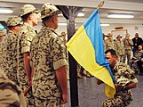 A Ukrainian soldier kisses the flag