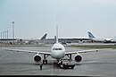 An Air Canada Airbus A319 in the foreground, and the Cargo Terminal in the background, showcasing an Antonov 124 to the right.