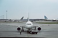 An Air Canada Airbus A319 in the foreground, and the Cargo Terminal in the background, showcasing an Antonov 124 to the right.