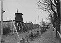 View including a watchtower, barracks, and barbed wire fencing.