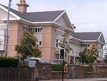 The new Bishop Auckland General facing onto Cockton Hill Road. The picture shows a 3-storey, sandstone clad building, with two large chimneys