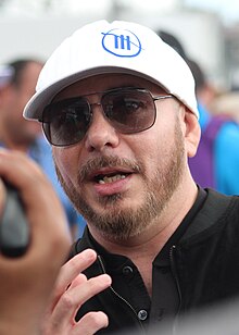 Headshot of a bearded Pitbull with sunglasses