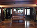 The entrance hall displays stained glass windows and wood interiors.