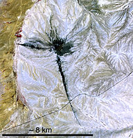 Ship Rock and associated dikes, in a cropped, marked, and lower-resolution image from original by NASA Visible Earth. This image was acquired by an ASTER sensor and colors are not photo-like.