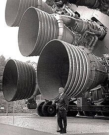 Von Braun in front of the five F-1 Saturn V test engines.