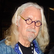 A man with shoulder-length light-coloured hair, beard and moustache