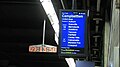 Single, vertical ceiling mounted screens, larger passenger capacity station type. Photographed at Town Hall, an underground station located in the Sydney City CBD.