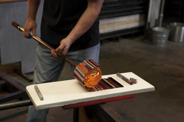 Patterns of cane and murrine picked up on a bubble of molten glass.