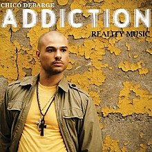 The cover features DeBarge wearing an olive green jacket, a yellow t-shirt and both a platinum Cross and black Ankh around his neck. Behind him is a wall with yellow paint falling off. Both the artist's name is on the top left corner and the album title is below it, colored in white. Underneath the album title on the right is "Reality Music" colored in black.