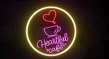 An image with a black background. Glowing objects shaped as a cup and a heart are seen in the center of the image, inside a circle. The series title is displayed on the lower part of the image.