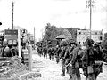 Tanks and Régiment de la Chaudière moving along Bernières-sur-Mer road, Normandy Beach head, 6 June 1944.