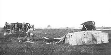 A photograph of a wrecked Tiger tank in a field