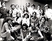 A black-and-white photograph of the band Sonseed, featuring 18 people sntanding and kneeling