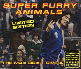 A dark-haired man in blue, white and yellow football kit scowls as he turns to his left, holding the index and middle fingers up on his right hand, his palm facing inwards. The hand points to an out-of-image figure, but appears to be pointing to the viewer. "Super Furry Animals" is rendered in yellow and red text across the top, while along the bottom the single's title is partially given: "The Man Don't Give a ****". The final word is obscured by a sticker, which itself claims that the word is used 50 times during the song