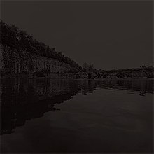 Photograph of a quarry lake at night.