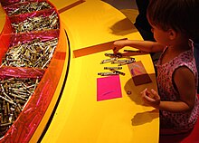 A young girl draws with Crayola crayons at the Crayola Factory