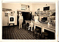 Inside the Fred J. Strain store, with Fred J. Strain and an unnamed man and young girl. Photo taken late 1930s.